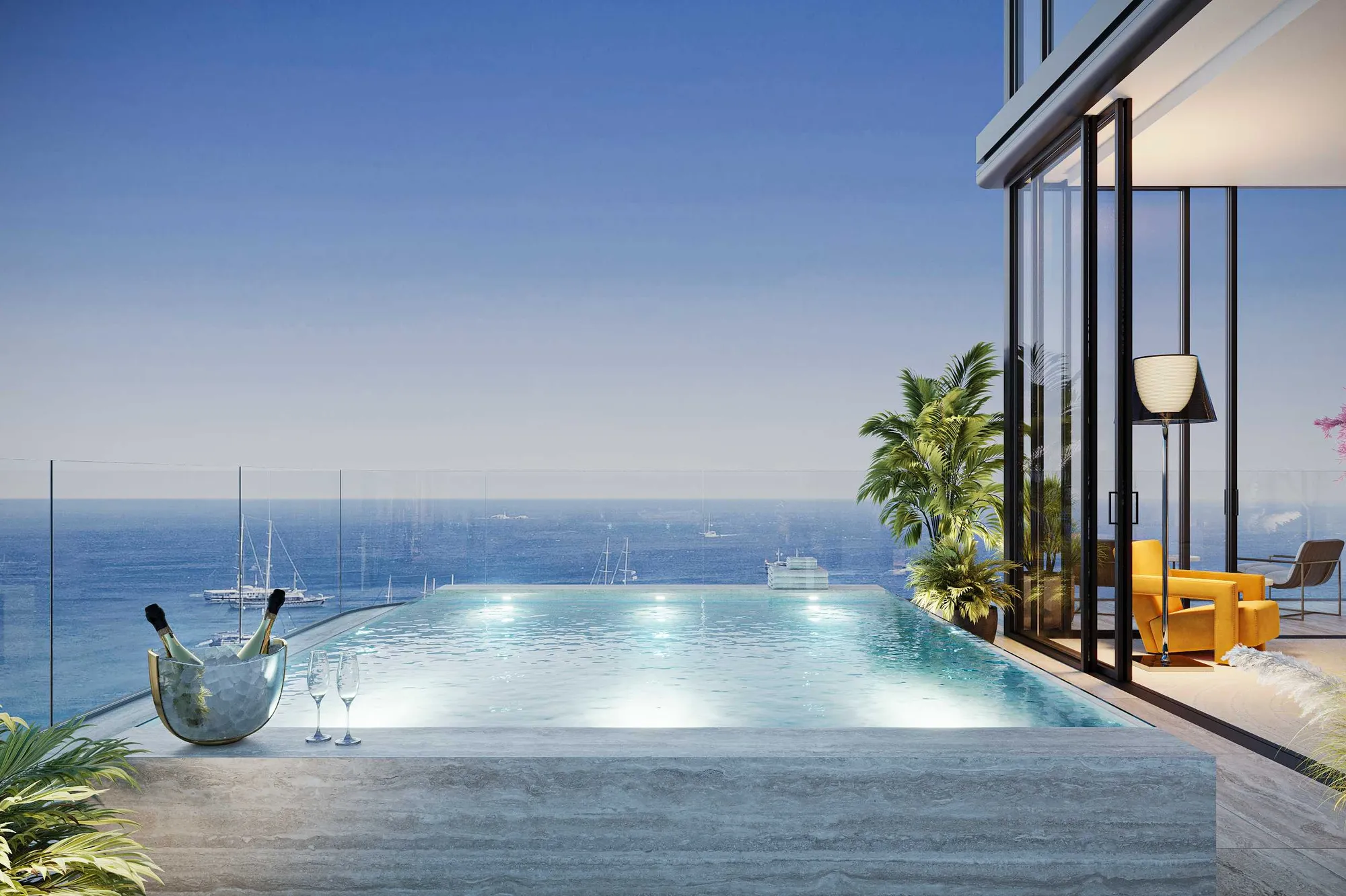 Infinity-edge terrace pool in travertine overlooking yachts on the sea